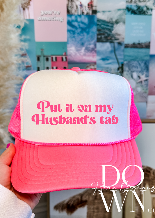 Put it on my husband's tab Trucker Hat